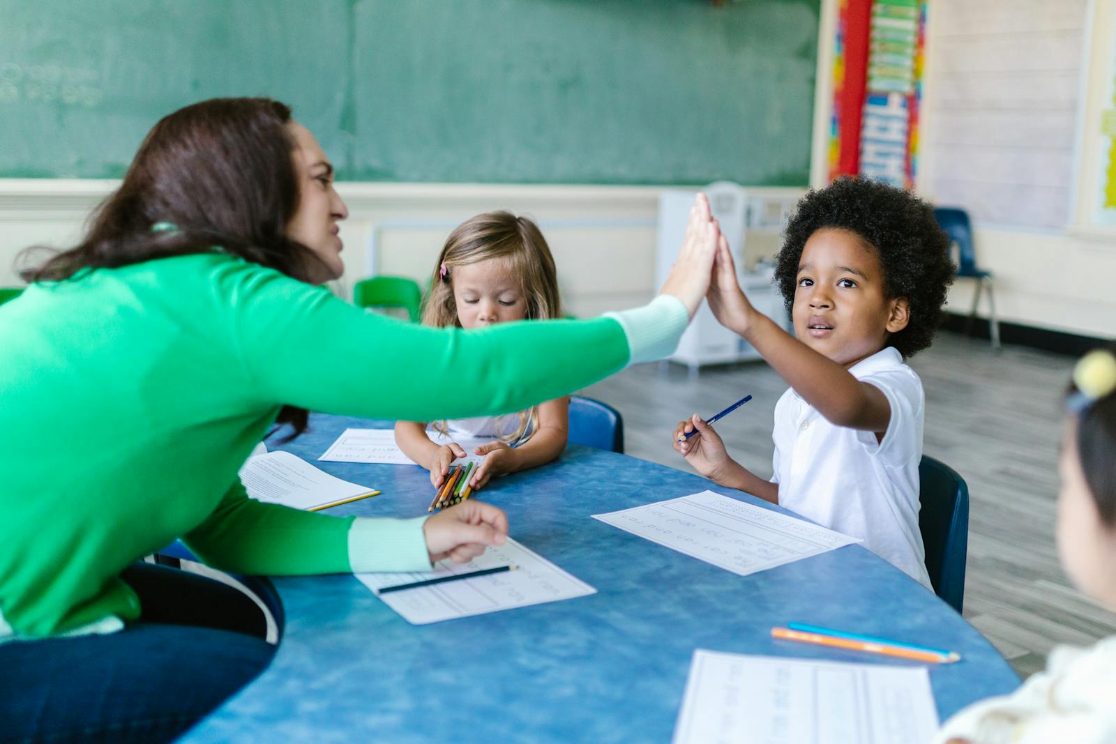 Teacher reading a book with attentive young children in a sunlit classroom